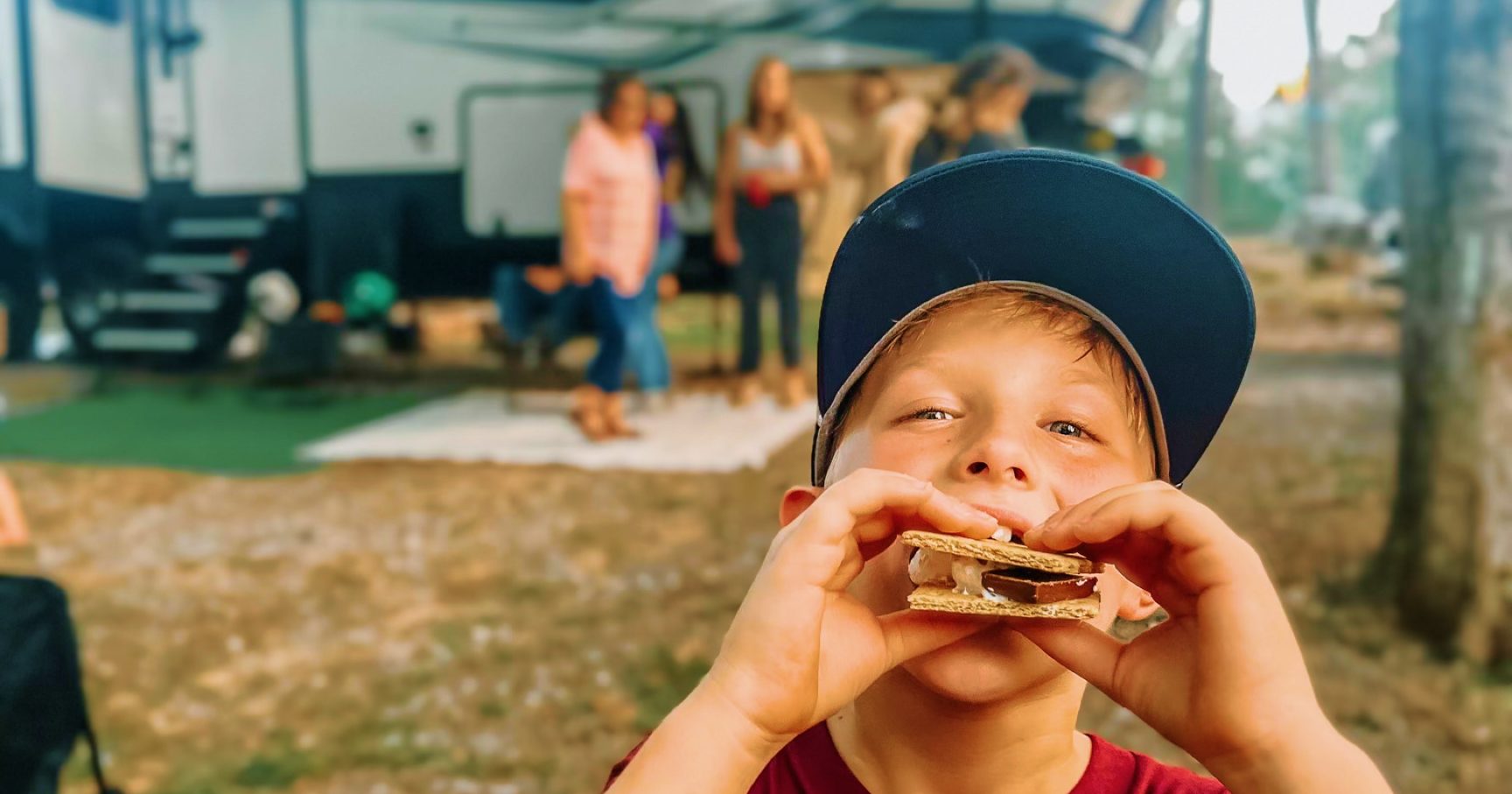 Kid eating s'mores at RV site in Mississippi